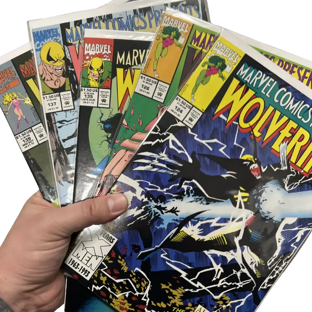 A fan of bagged comic issues held in one hand